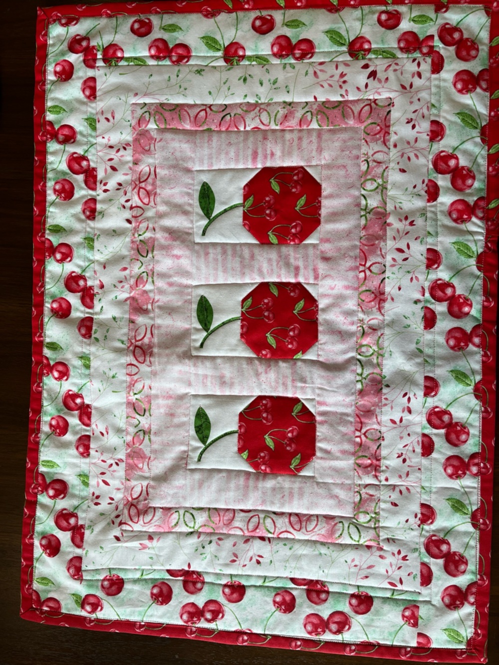 Cherry Patchwork Table Runner  or Wall Hanging Red & Green
24 in by 18 in